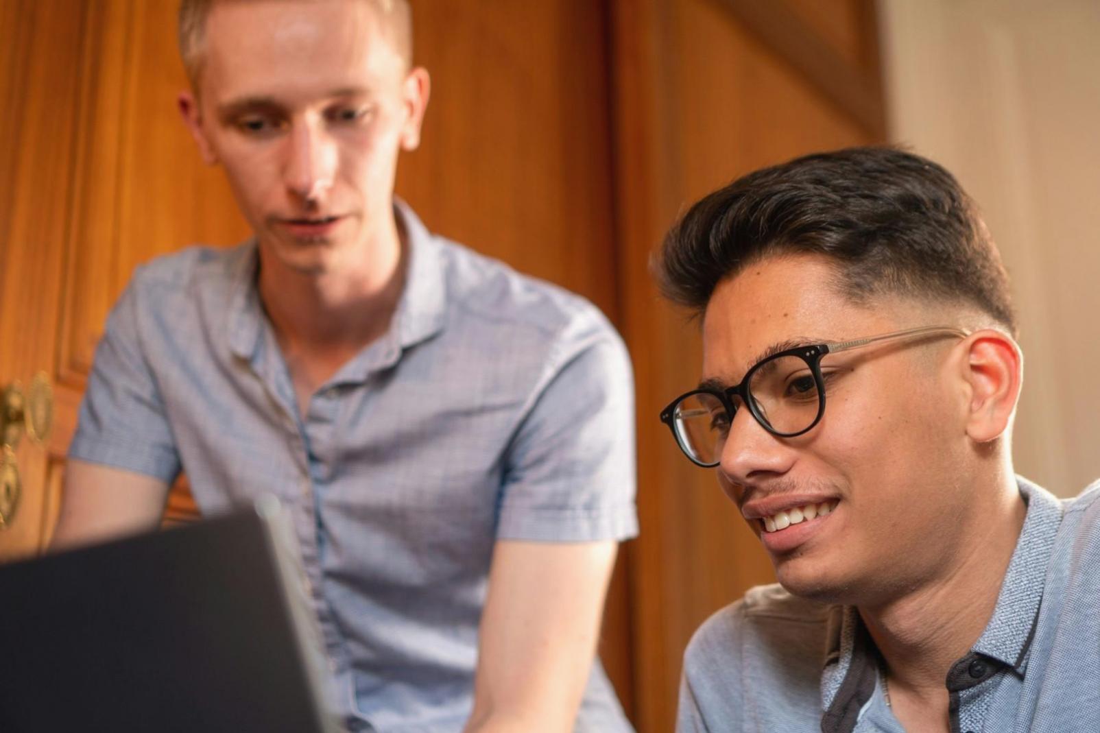 Business professional analyzing financial reports and budget data on laptop