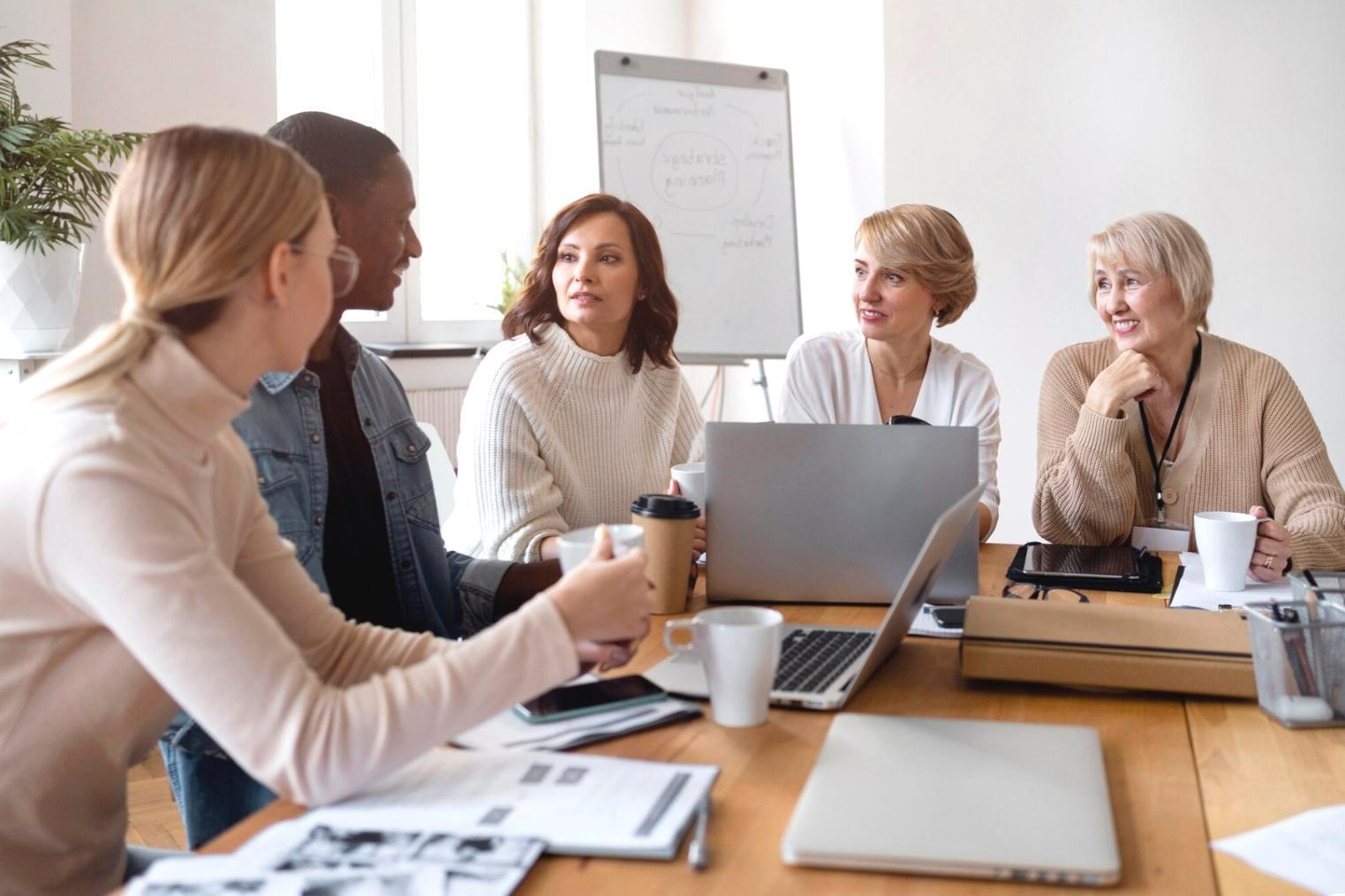 Team meeting discussing budget optimization strategies based on benchmark analysis